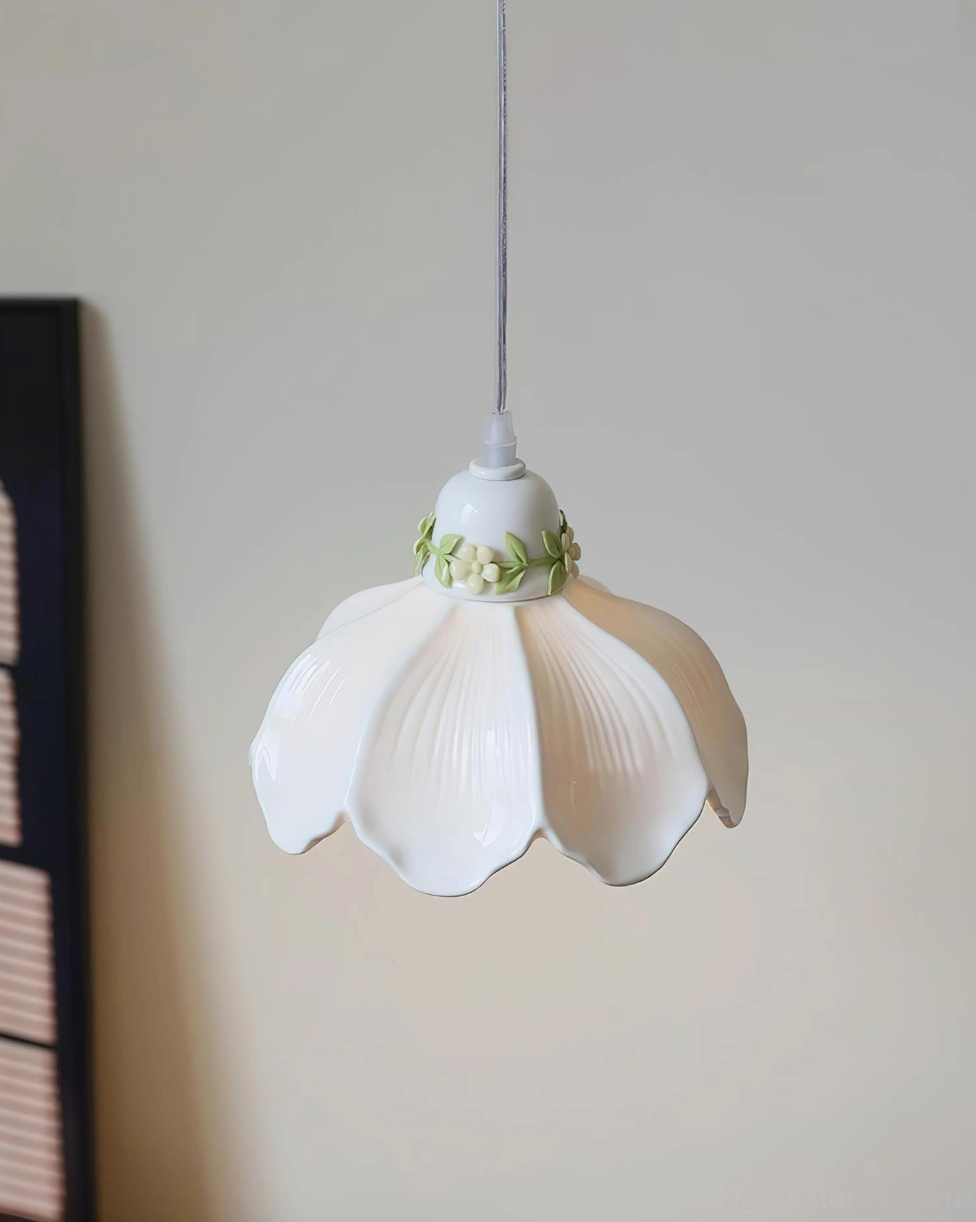 Hand-painted ceramic petal pendant light in home interior setting, milk white shade with green floral accent details