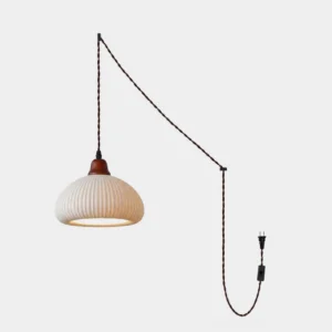Sidra ribbed ceramic plug-in pendant light with off-white fluted shade and oak canopy, front studio view