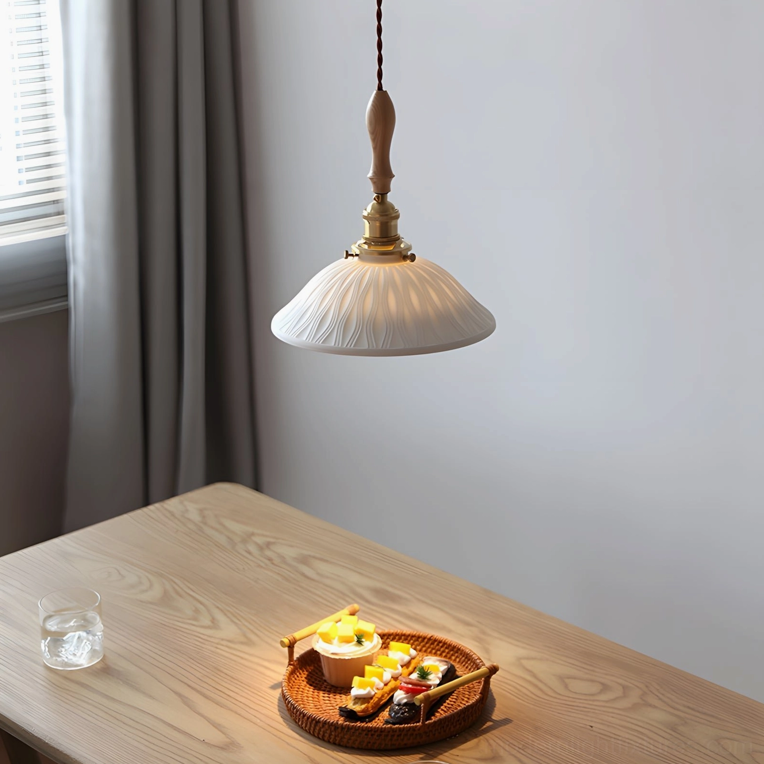 Ceramic ripple pendant lamp overhead view illuminated above dining table with warm ambient glow