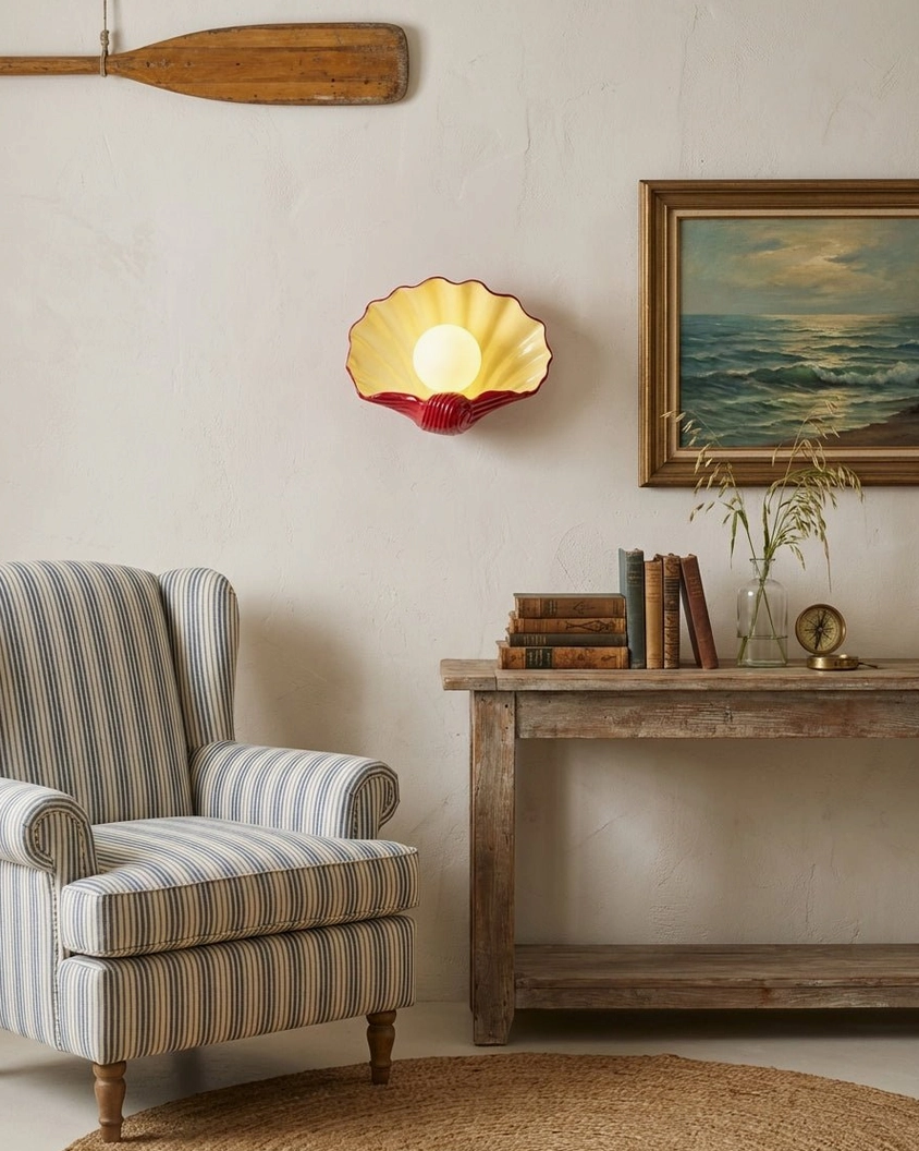 Coastal wall sconce mounted indoors with warm glowing light, vintage rustic living room setting, ceramic shell design
