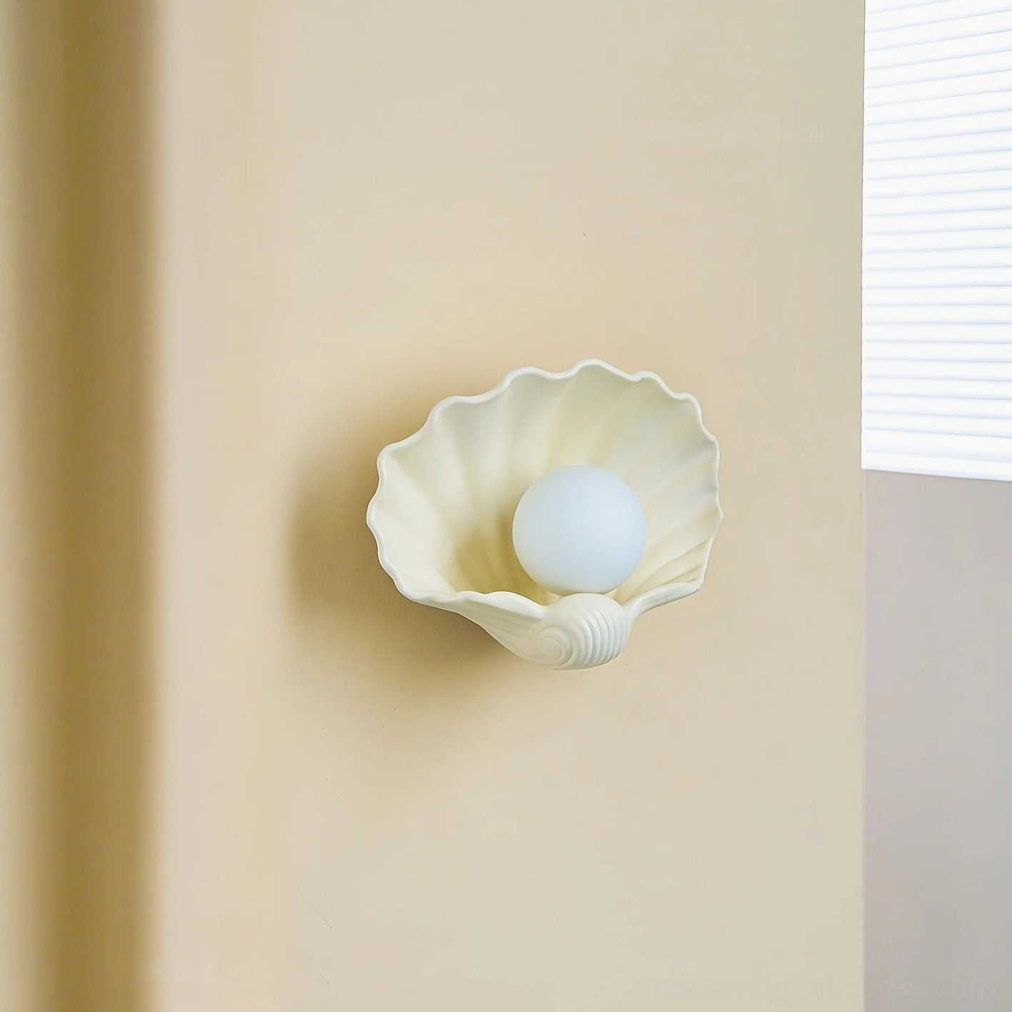 Ceramic scallop wall sconce mounted in bathroom mirror area, damp-rated fixture, coastal bathroom lighting