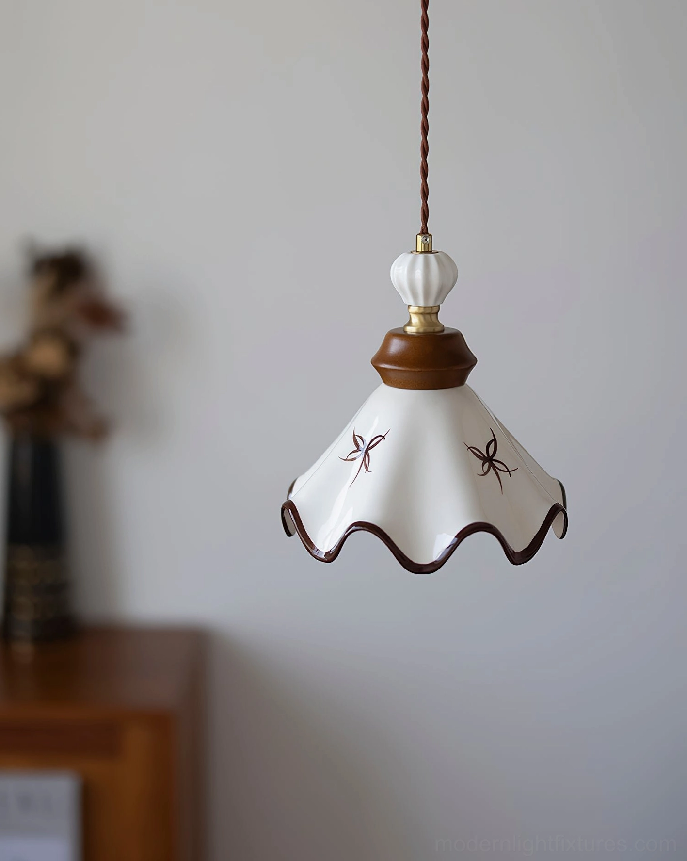 Ceramic scalloped pendant light with brass components and artistic hand-painted brown detailing on ceramic shade
