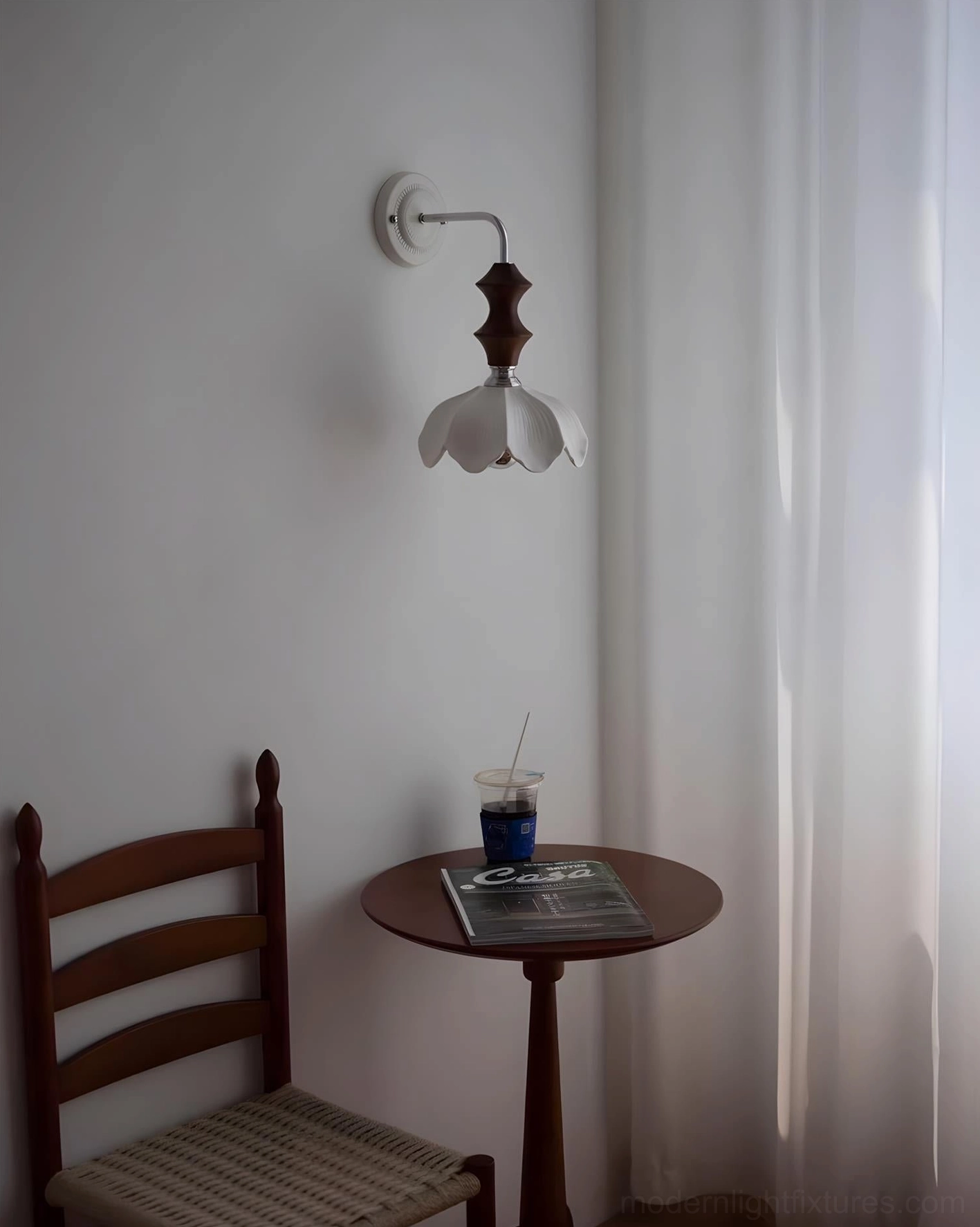 Ceramic floral wall sconce with chrome metal arm and sculptural wood accent close-up detail