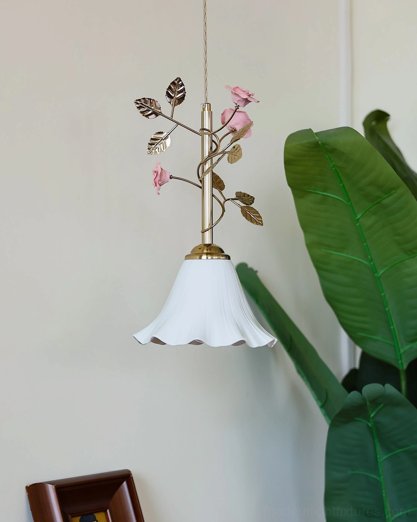 Botanical pendant fixture displaying cream ceramic shade construction and vintage brass metalwork