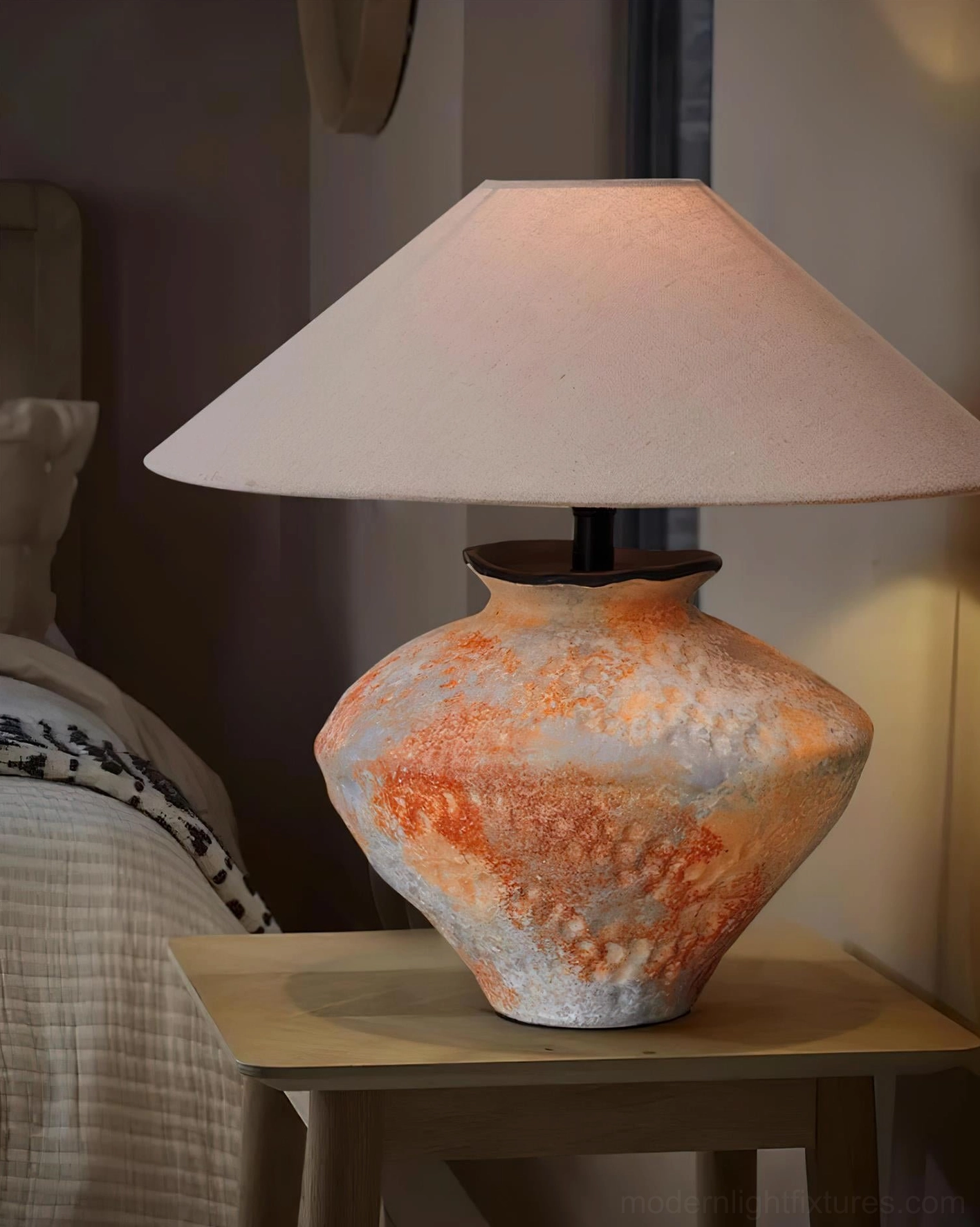 Ceramic table lamp small bedroom side table three-quarter view dim warm indoor lighting