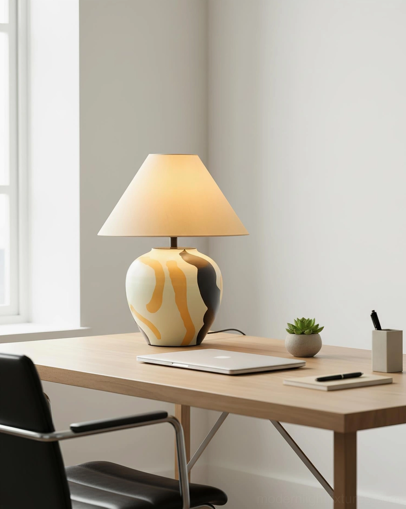 Desert Swirl ceramic base table lamp with swirled glaze pattern and tan tapered fabric shade on home office desk