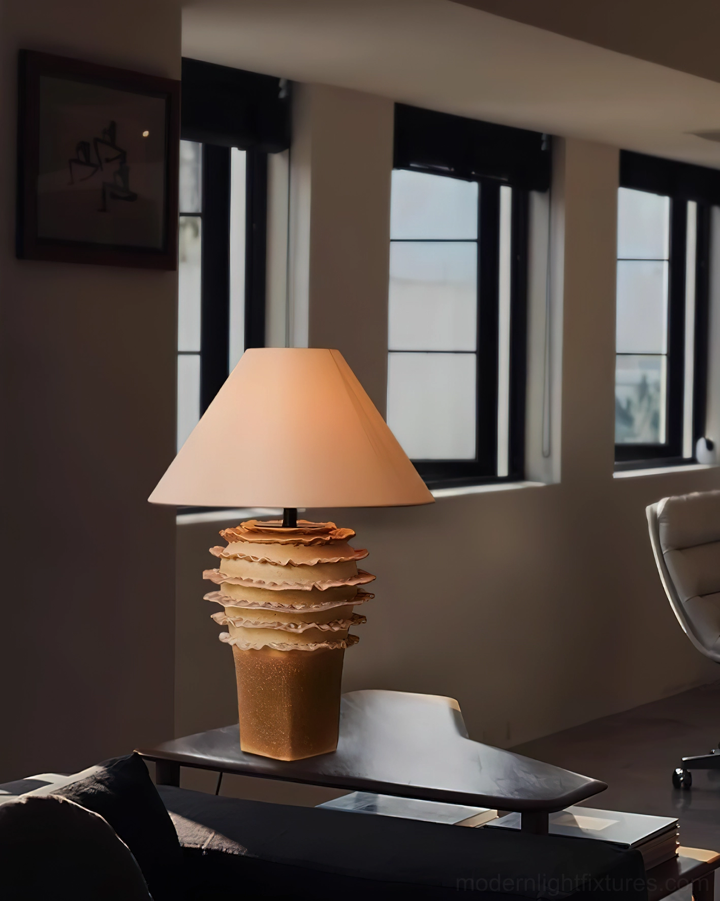 Organic ceramic table lamp in modern living room setting near windows and dark sofa
