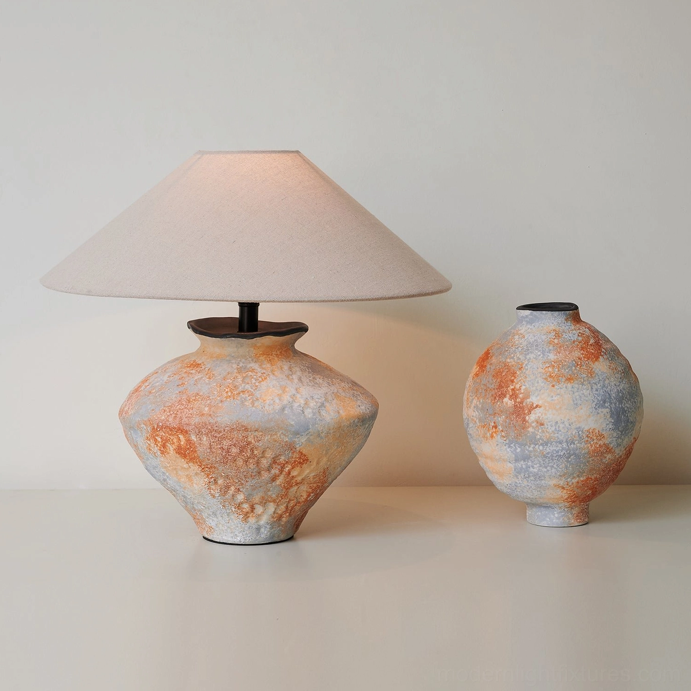 Side profile view of ceramic table lamp and decorative vase showing textured ceramic craftsmanship