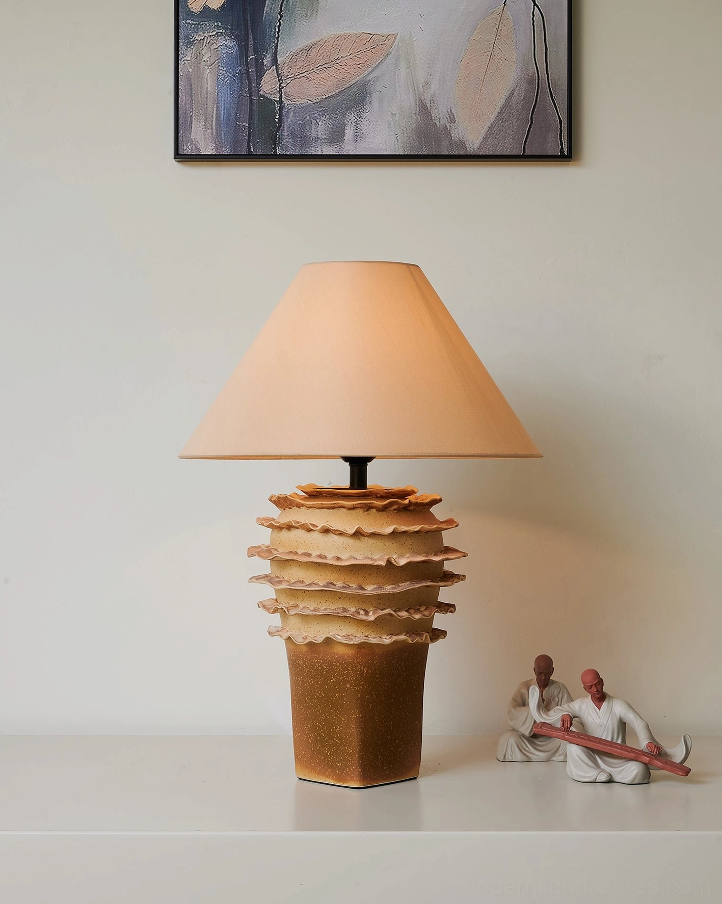 Handcrafted ceramic table lamp with textured layered base and neutral fabric lampshade interior styling