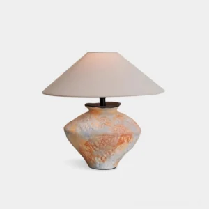 Mays ceramic table lamp with distressed wabi-sabi base and cream fabric shade, front studio view