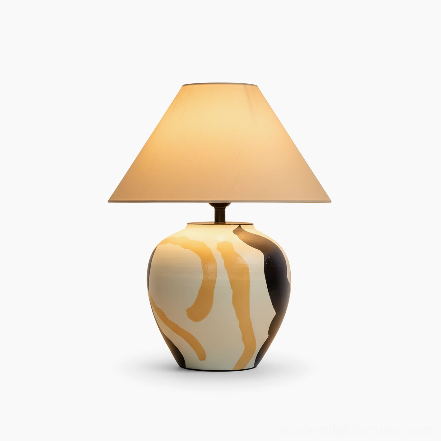 Hand-painted ceramic table lamp with lit warm yellow glow, front studio shot with swirled glaze design and fabric shade