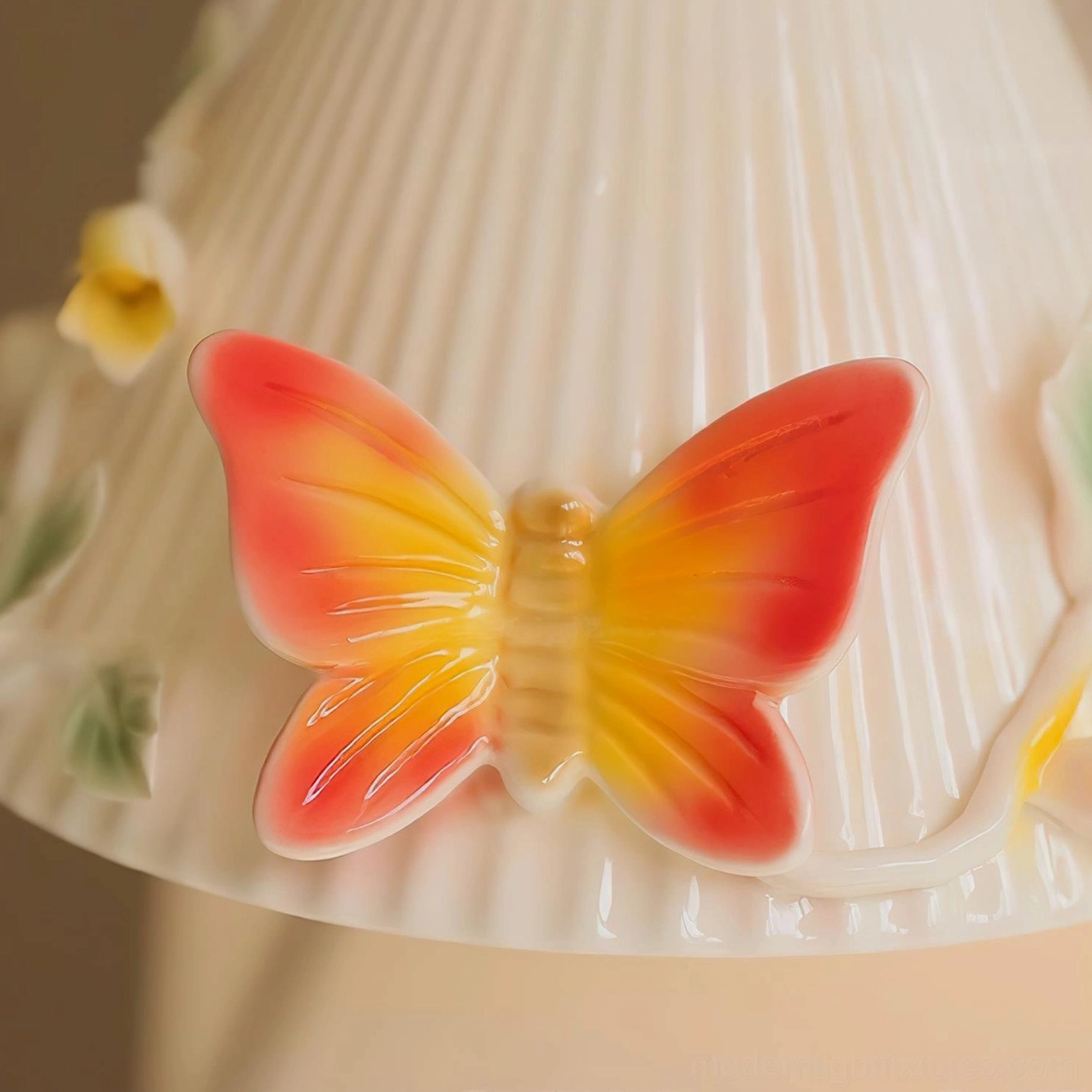 Macro close-up detail of Florynna ceramic wall sconce hand-painted gradient embossed butterfly decoration on ribbed textured ceramic surface