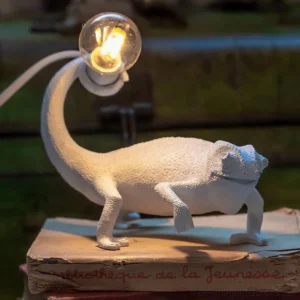 Chameleon resin table lamp low angle view vintage book interior styling warm lighting