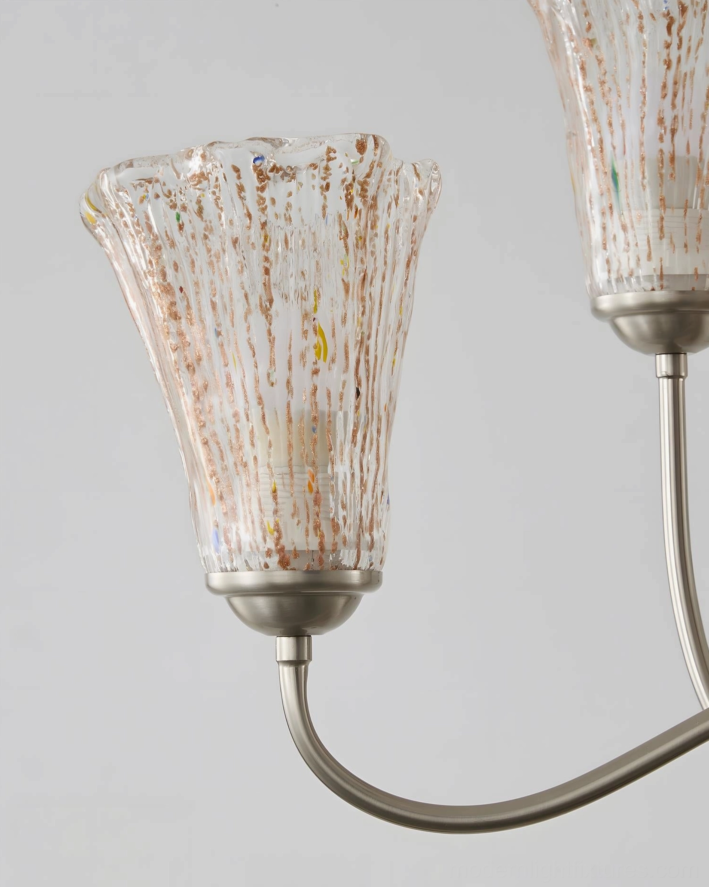Close-up of Mid-Century Chandelier Brushed Nickel Arm and Fluted Amber Glass Shade with Gold Flecks
