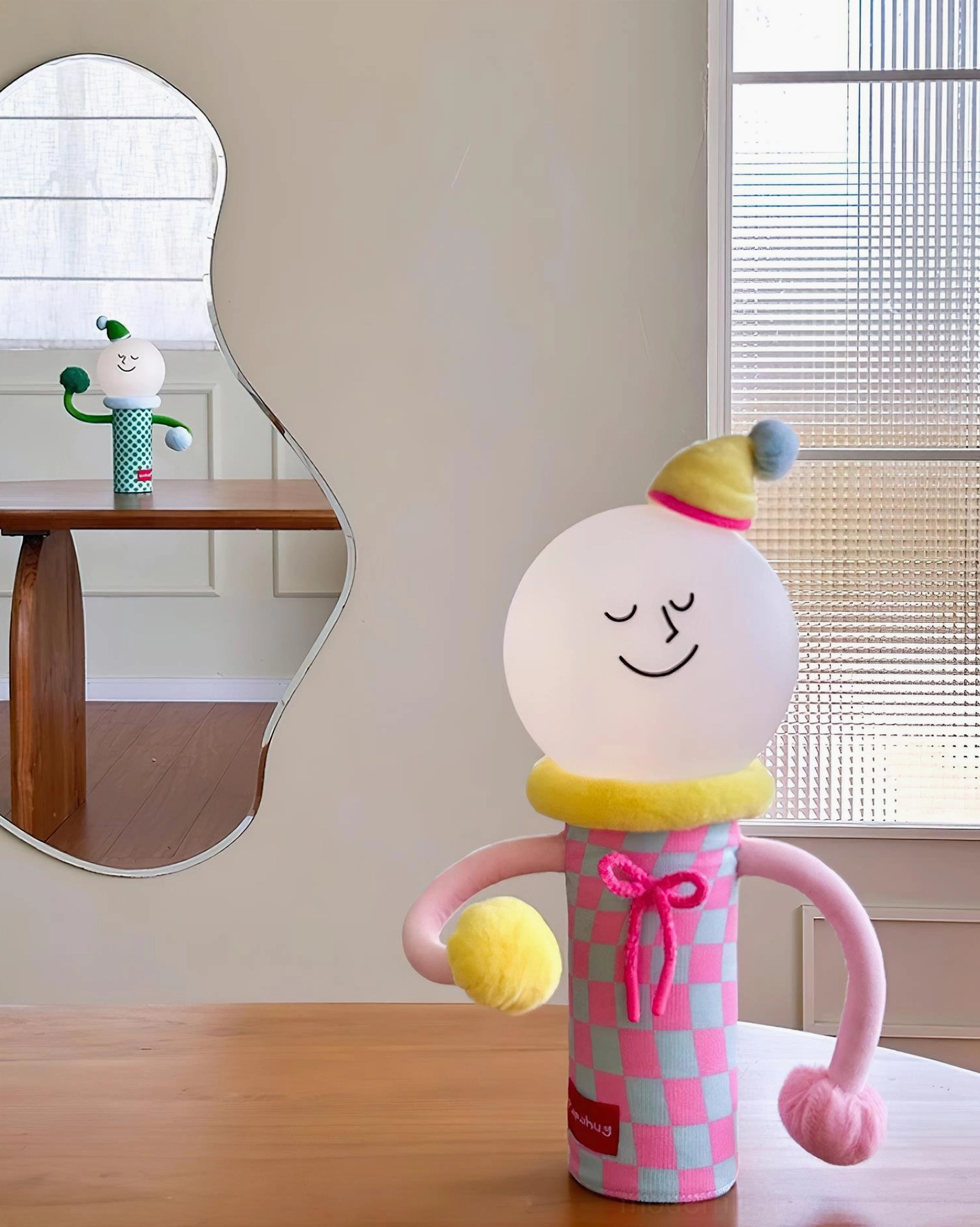 Articulated character table lamp beside furniture styling living space arrangement