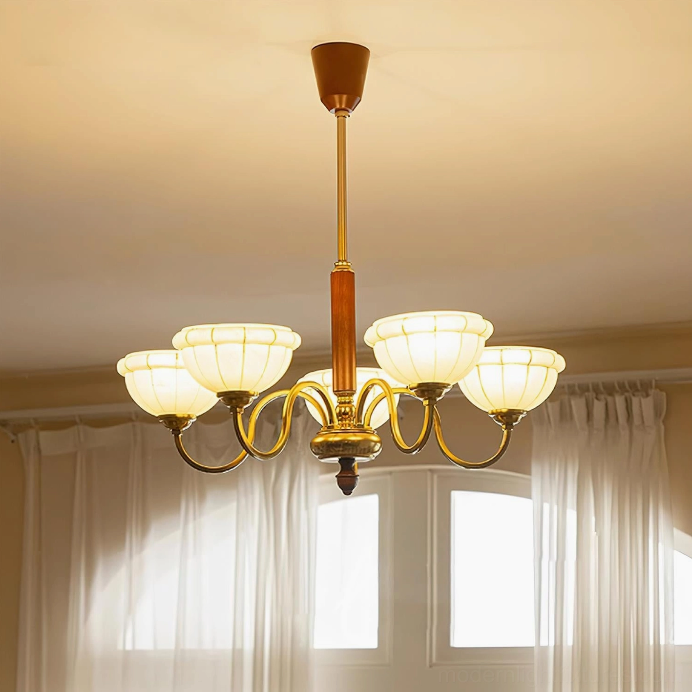 Charlie mid-century modern chandelier detail view showing brass arm curves and frosted glass shade texture