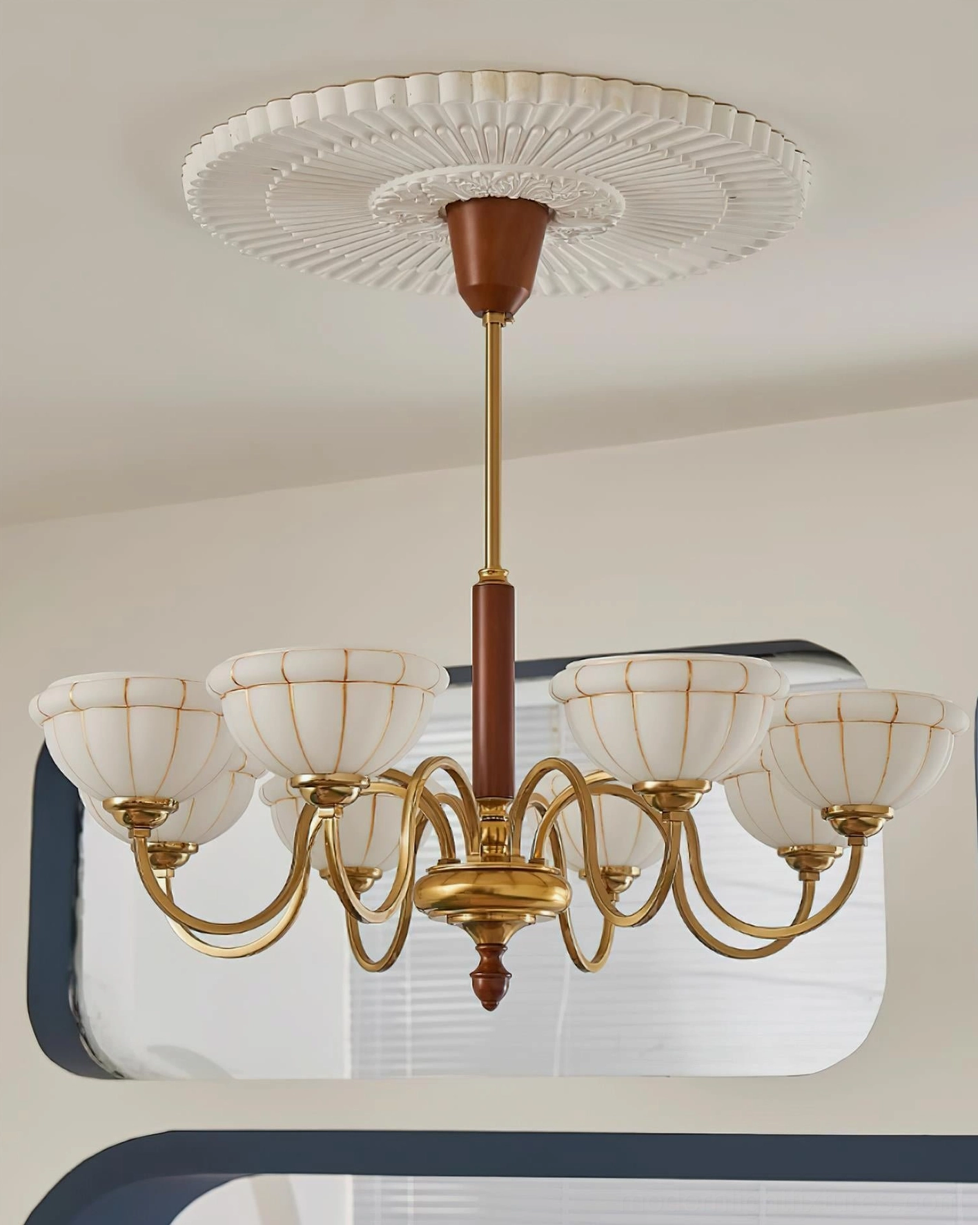 Complete Charlie chandelier eight-light fixture with brass hardware wood accents ribbed glass overhead view