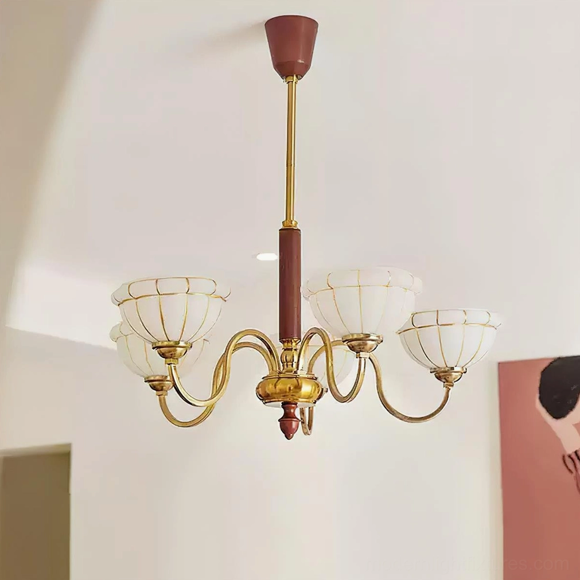 Charlie chandelier with six frosted ribbed glass shades and brass frame mounted in residential interior