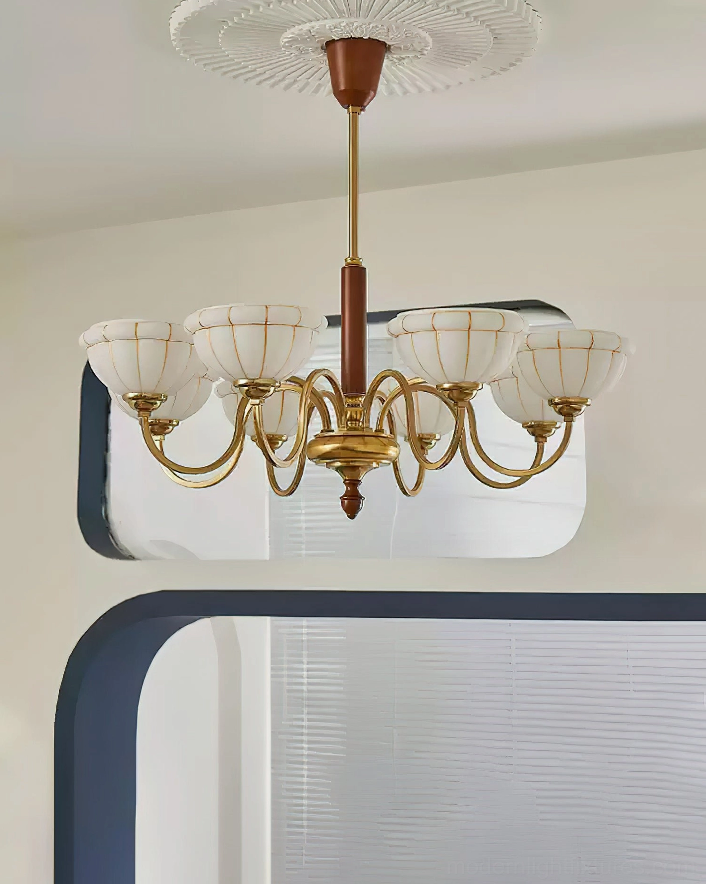 Charlie vintage chandelier with six frosted glass shades in residential interior setting with arched mirror