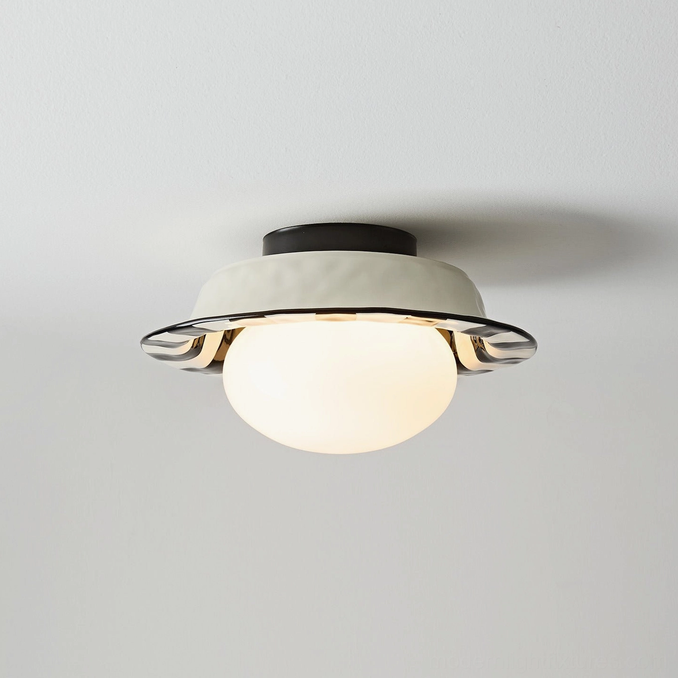 Lit checker ceiling lamp showing warm light diffusion through frosted glass sphere with decorative metal trim