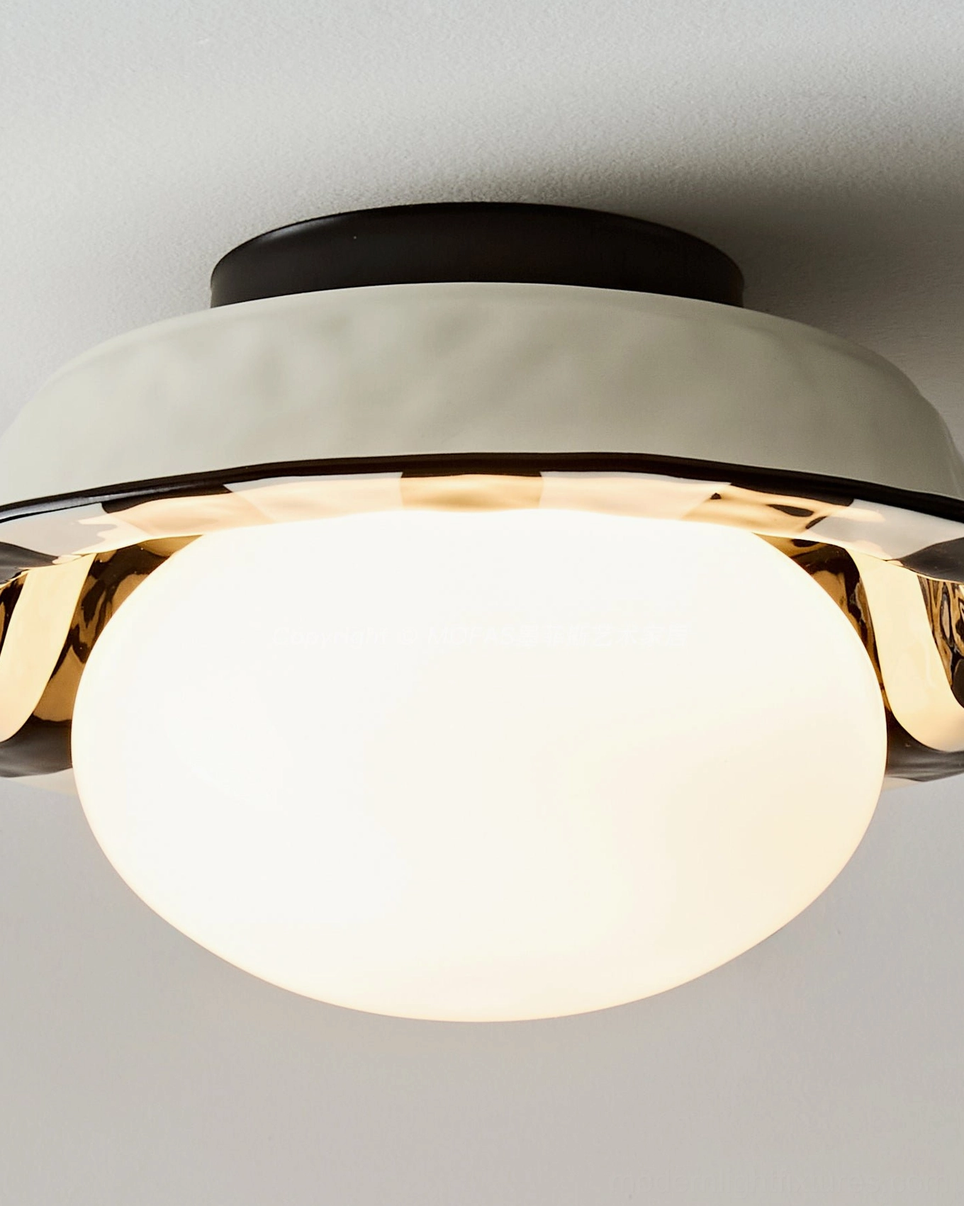 Right-side close-up of checker ceiling light fixture displaying cream housing, silver metallic accents, and glowing frosted glass