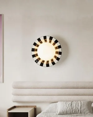 Checker wall lamp mounted above modern bedroom headboard creating sculptural accent lighting in contemporary interior