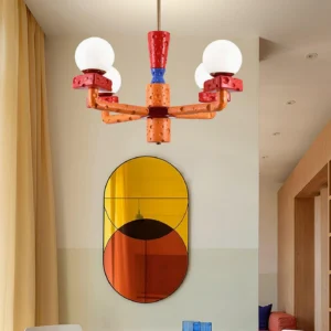 Modern cheese-inspired pendant chandelier low angle view showing orange red and white blocks in warm residential interior setting