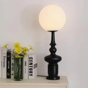 Contemporary globe table lamp positioned on bedroom bedside table with decorative styling