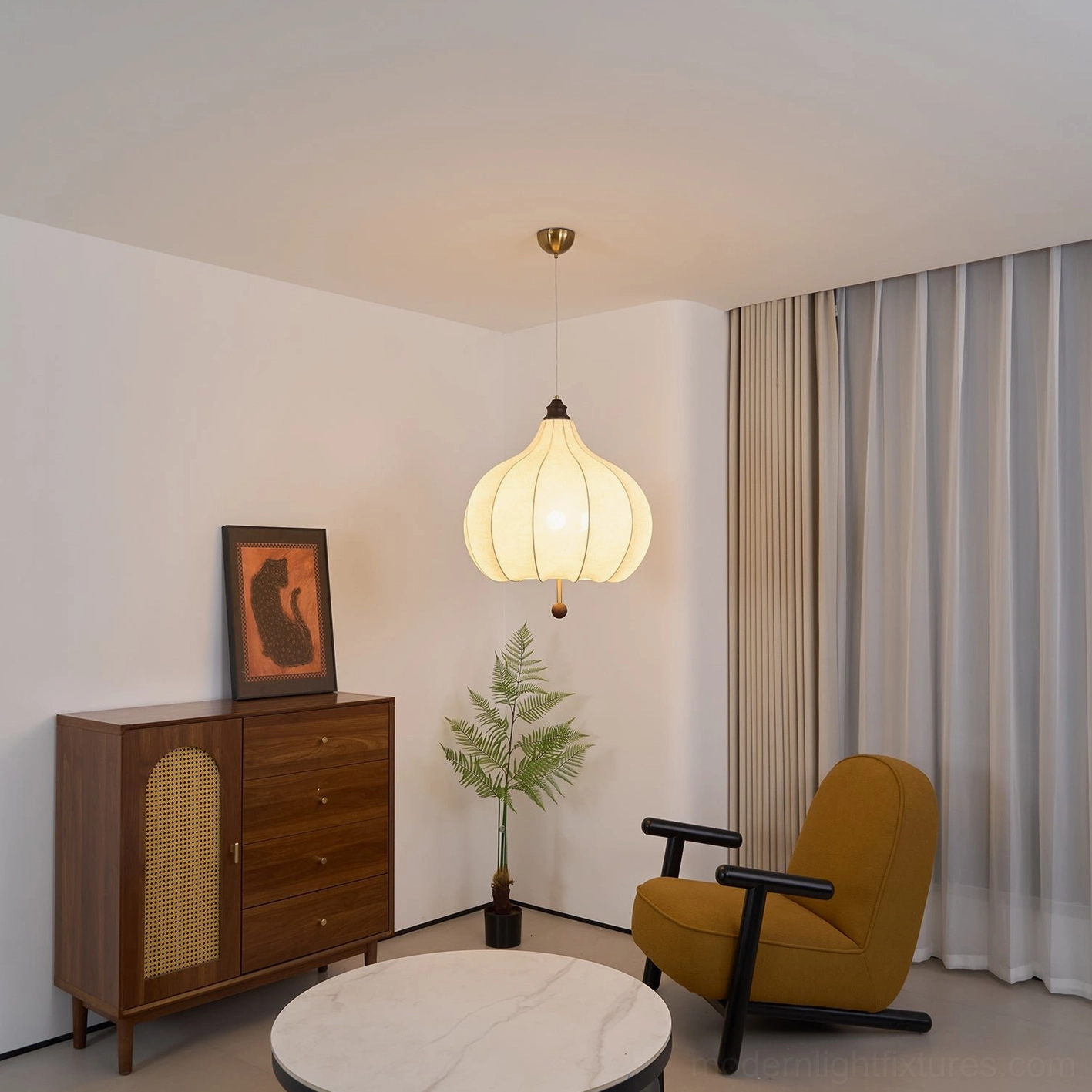 Vintage botanical pendant light with fabric shade in gallery-style room setting with artwork