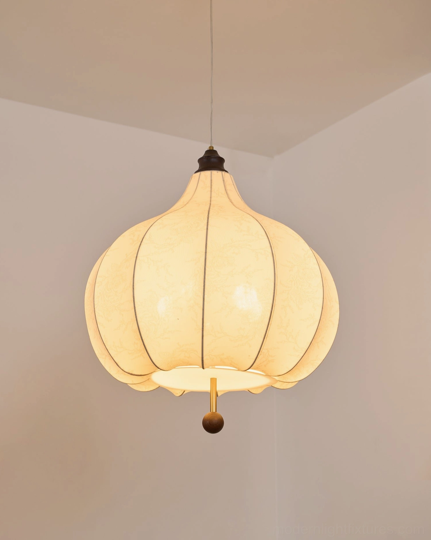 Botanical fabric pendant lamp demonstrating adjustable cord length and height customization capability