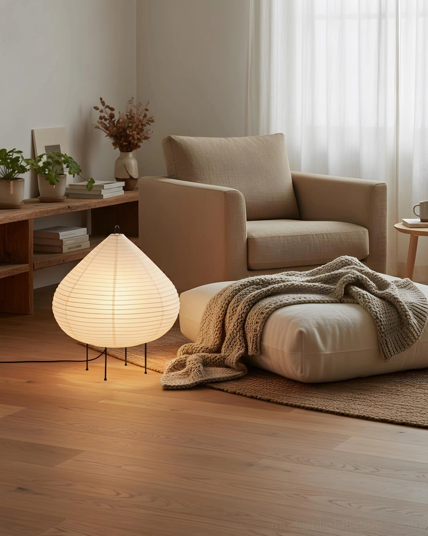 Sculptural chestnut ribbed shade table lamp in lounge seating area with linen armchair