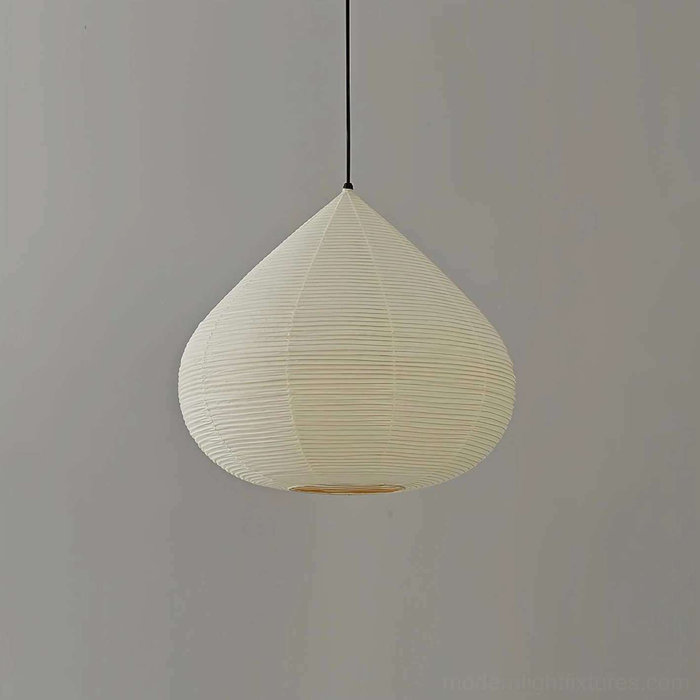 Japanese chestnut pendant light with matte black cord displaying warm ambient illumination
