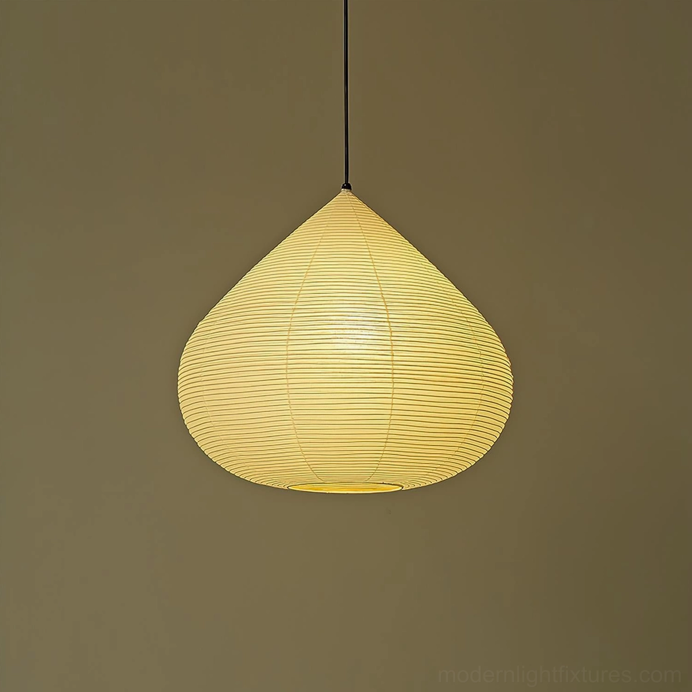 Close-up of glowing chestnut pendant light showcasing warm ribbed paper shade texture