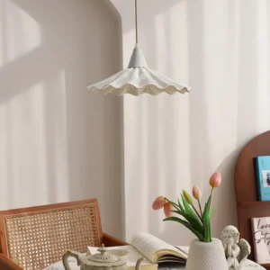 Christie bone china pendant light hanging above dining table in home setting with natural light