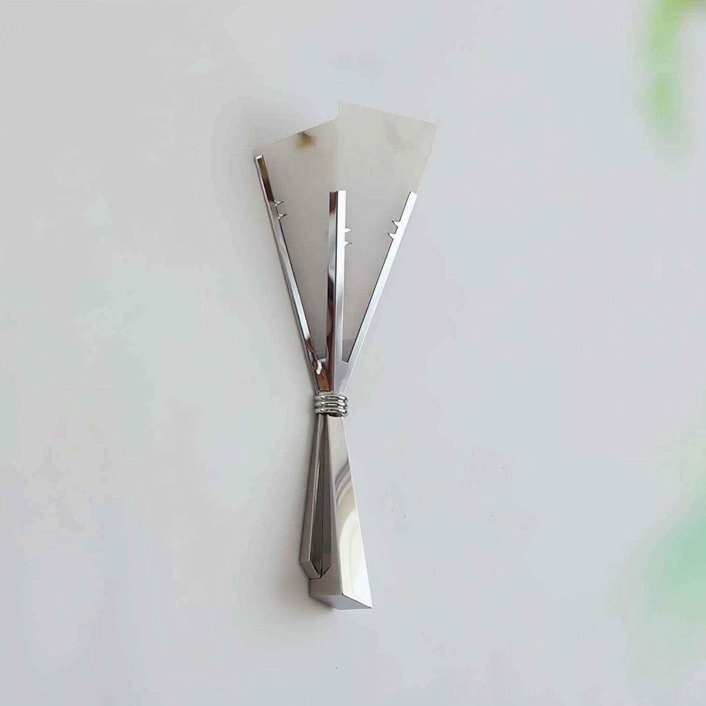 Chrome Art Deco wall sconce demonstrating polished metal reflection and sculptural elegance in luxury residential setting