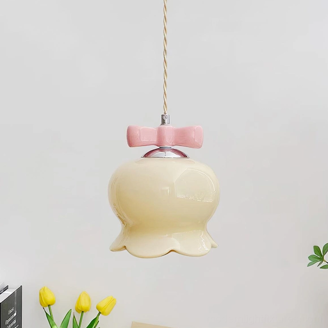 Chrome and beige ceramic pendant light displaying scalloped design and metal fixture