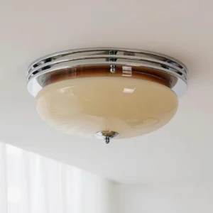 Chrome and brown dome ceiling light mounted on residential ceiling with warm ambient glow - overhead angle view