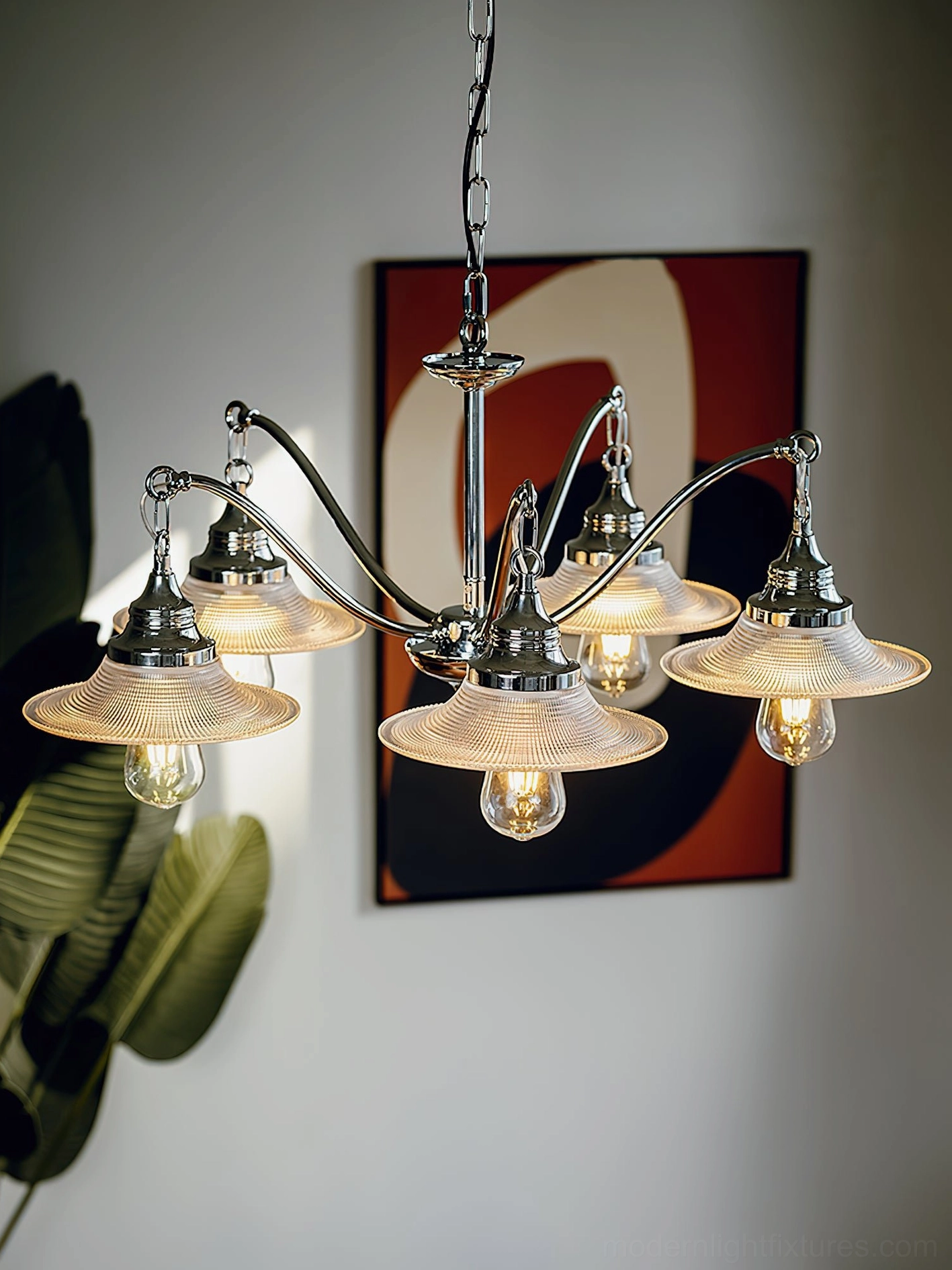 5-head chrome curved arm chandelier close-up showing detailed ribbed glass shades and warm exposed bulbs