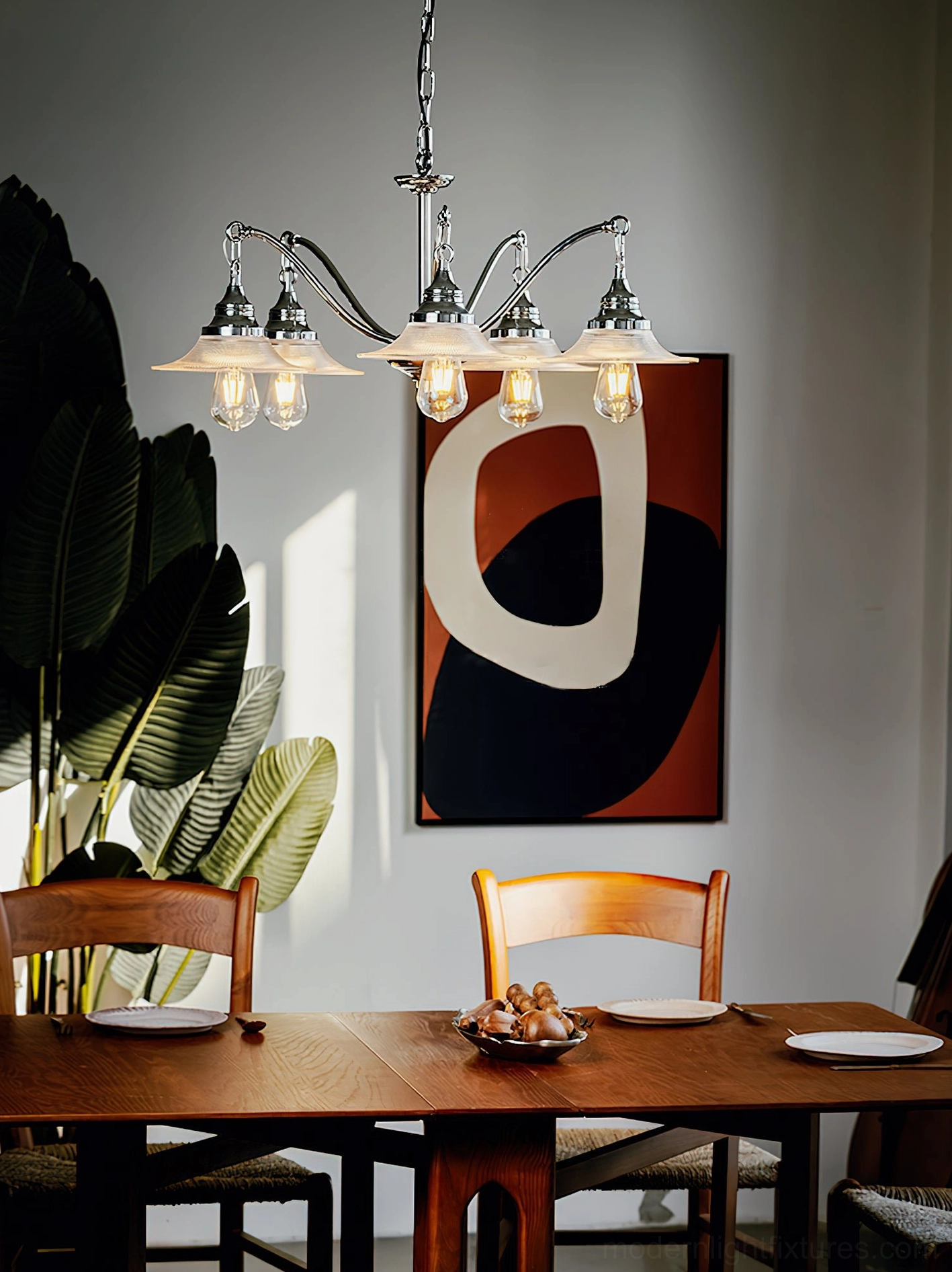 5-head chrome pendant chandelier above wooden dining table creating warm ambient lighting in dining room