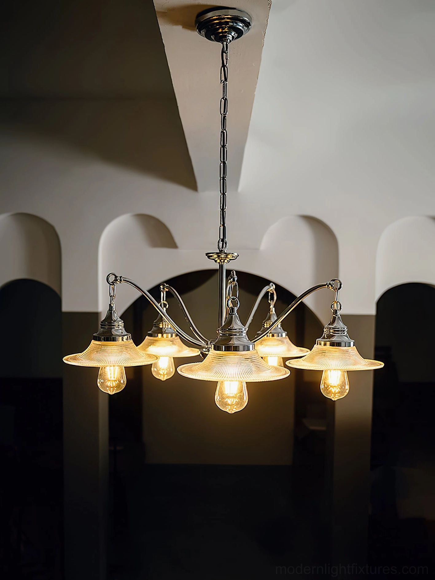 5-head chrome chandelier with smooth flat glass shades mounted in traditional arched hallway entryway