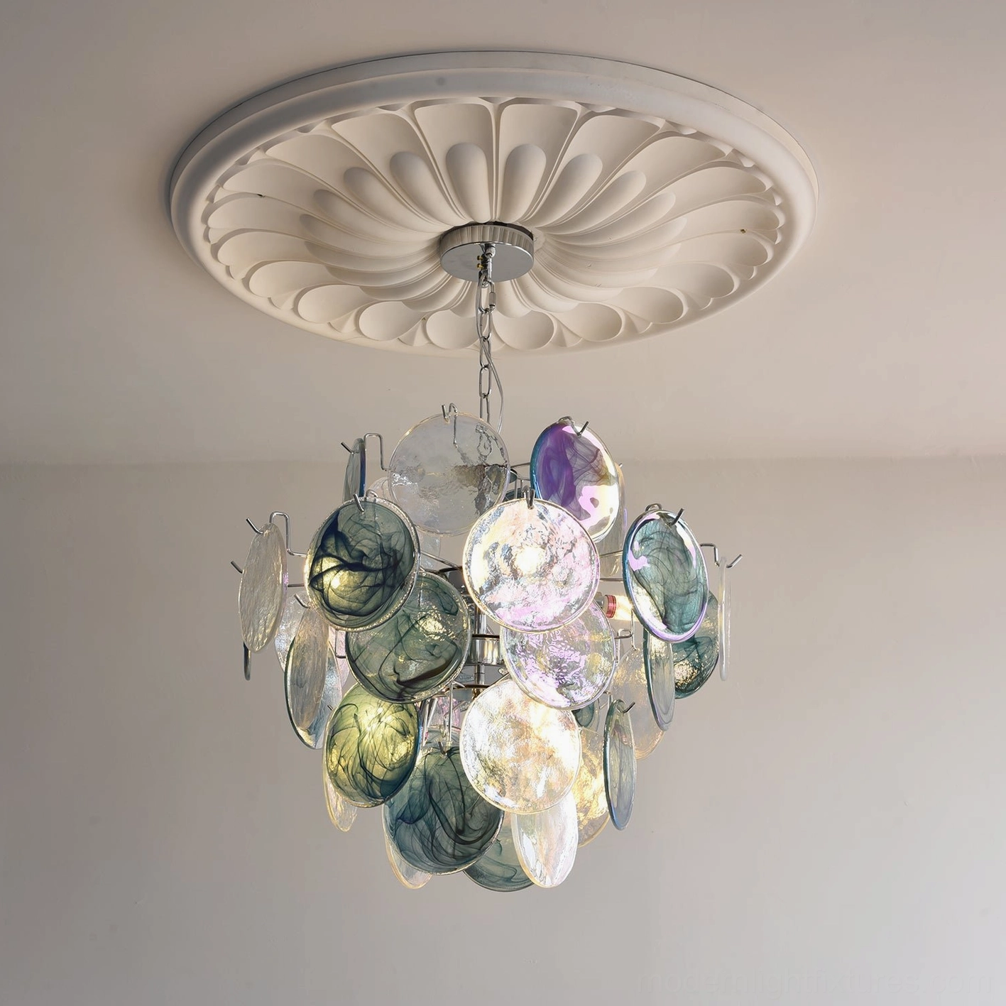 Chrome frame detail of iridescent glass disc pendant light showing polished metal construction