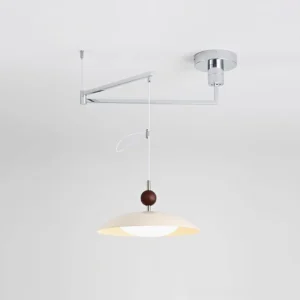Modern chrome swing arm pendant light with white acrylic shade and hanging cord, side overhead perspective