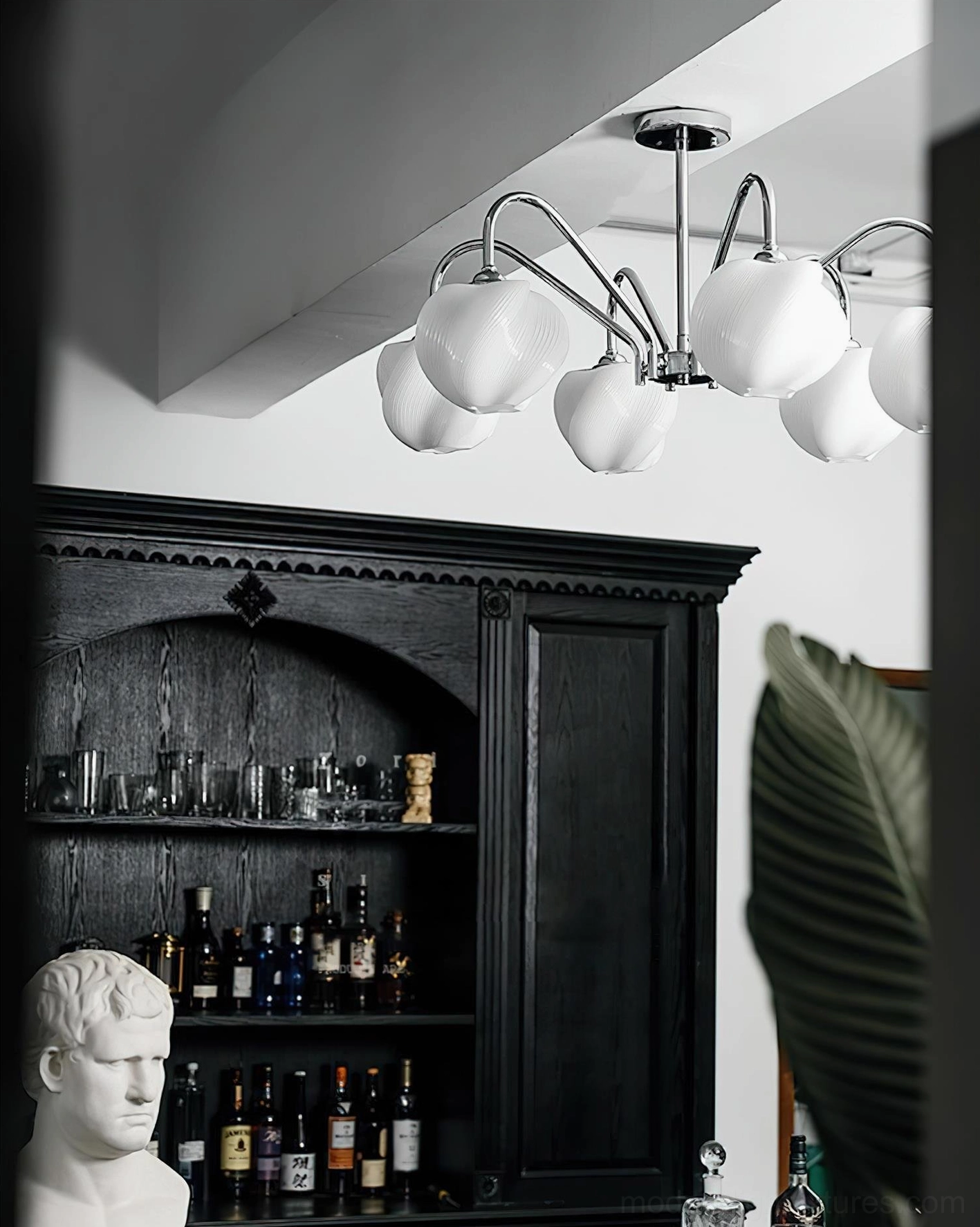 Modern petal sputnik chandelier with polished chrome frame and ribbed frosted white acrylic shades suspended above dark wood cabinet
