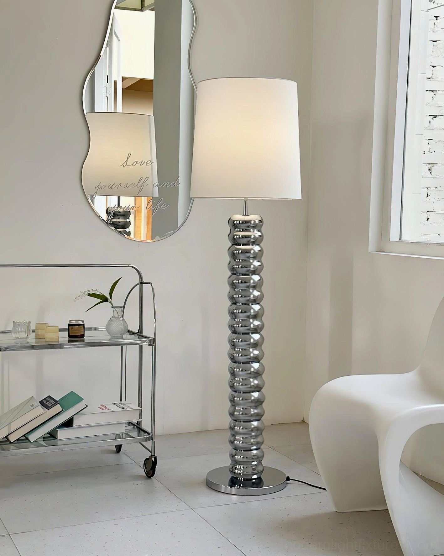 Chrome ribbed glass floor lamp with modern metal hardware in contemporary living room
