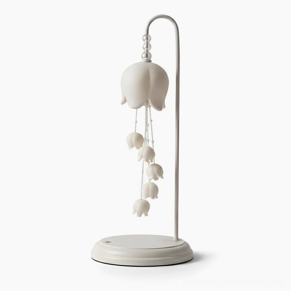 Chyme Charge table lamp side three-quarter angle showing curved metal chains and ceramic bell forms