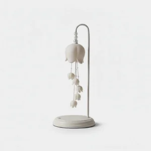 Chyme Charge white ceramic table lamp front view with bell-shaped pendants and matte finish