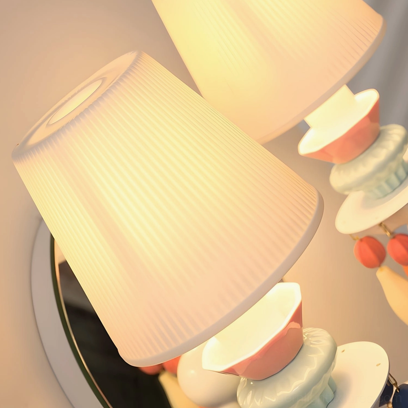 Contemporary Cielora wall sconce close-up of artisanal ceramic beads and soft pleated fabric illumination in modern minimalist setting