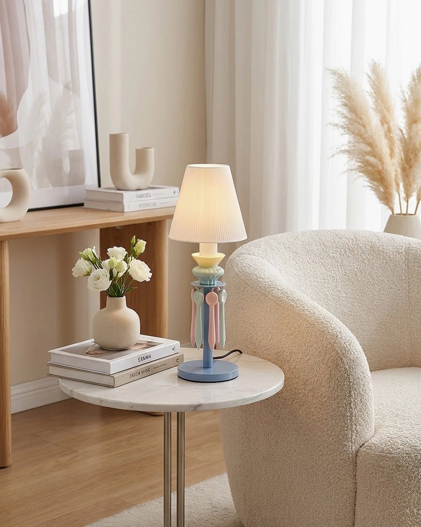 Cielora blue tassel table lamp in compact apartment living area on marble side table with fresh pampas grass floral arrangement