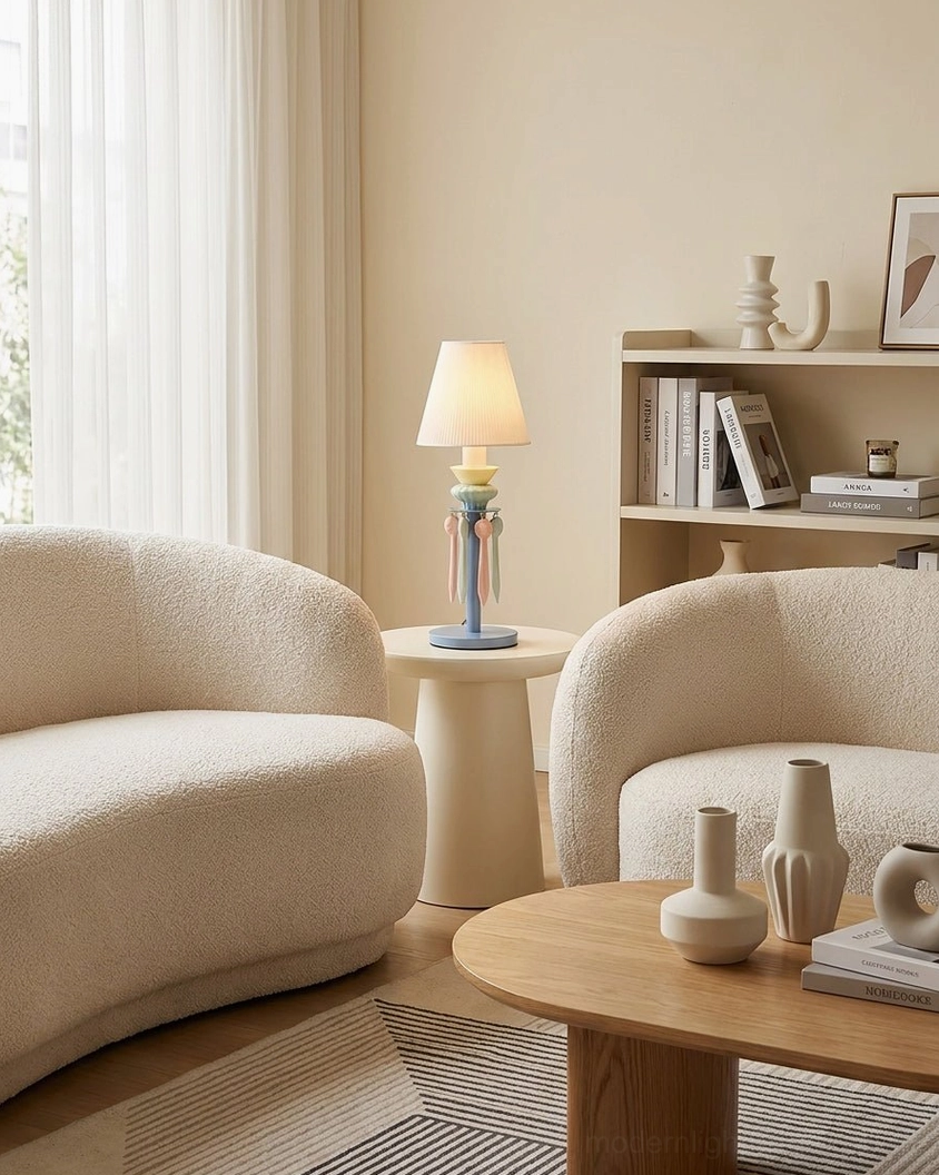 Cielora tassel table lamp in blue placed on small wooden side table in modern living room with curved sofa styling
