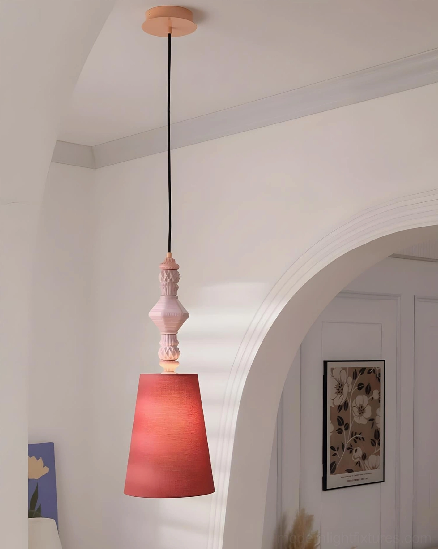 Dark red conical fabric shade modern ceramic totem pendant light in minimalist white arched hallway, bohemian style